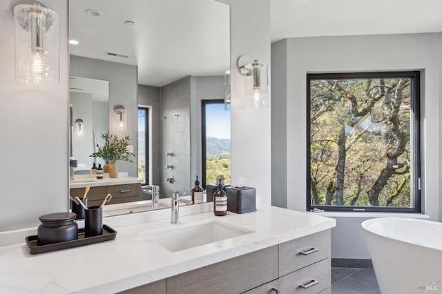 full bathroom with baseboards, a soaking tub, vanity, and tile patterned flooring