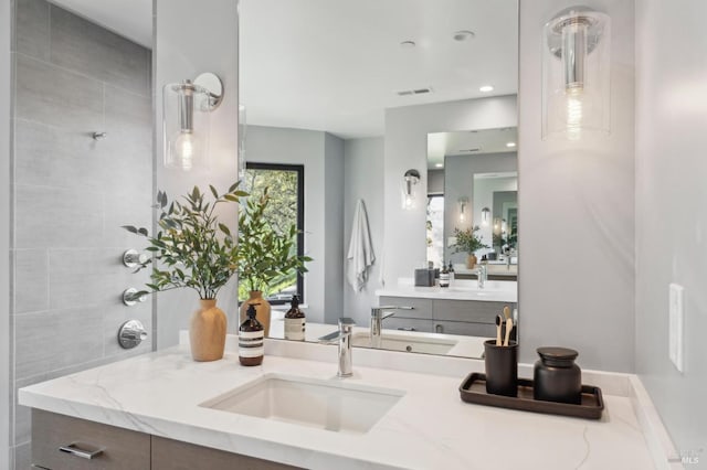 full bathroom featuring vanity and visible vents