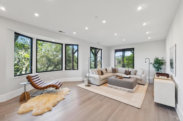 living room featuring wood finished floors, recessed lighting, baseboards, and visible vents