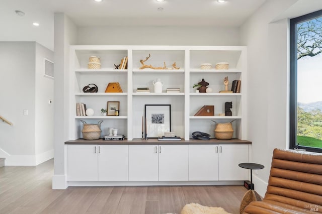 interior space featuring light wood finished floors, stairway, recessed lighting, and baseboards