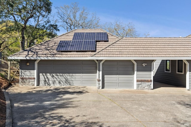 detached garage featuring solar panels