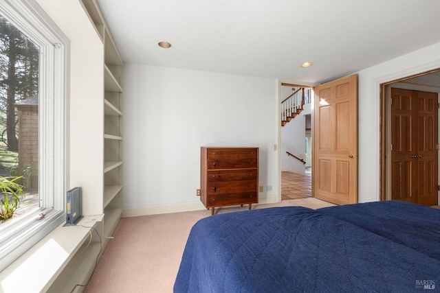 unfurnished bedroom featuring recessed lighting, baseboards, and light colored carpet