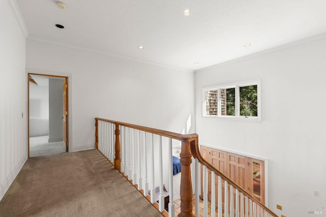corridor with recessed lighting, an upstairs landing, light colored carpet, and crown molding