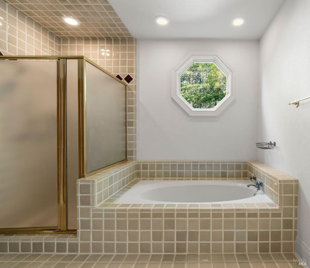 full bath with a stall shower, a bath, and recessed lighting