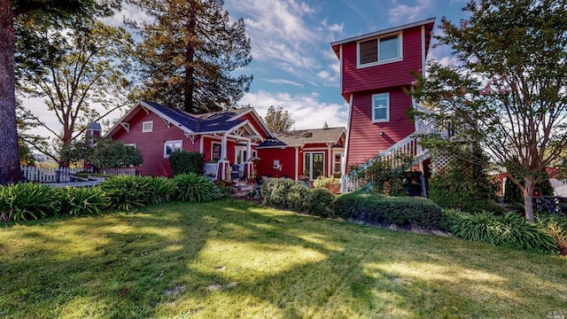 rear view of property with a yard
