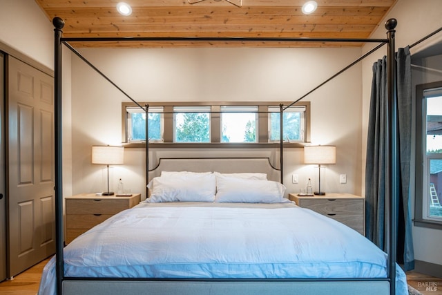 bedroom featuring wooden ceiling and light wood finished floors