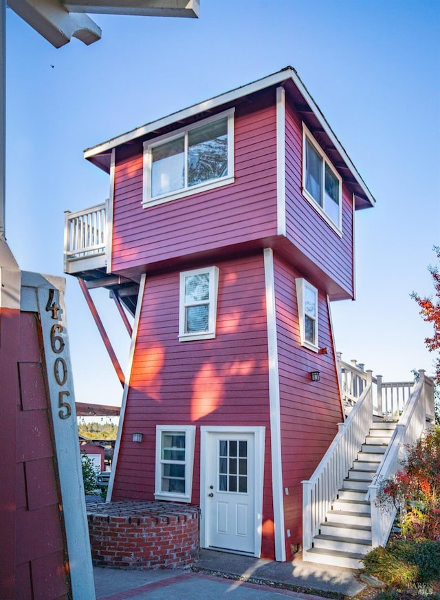 view of front of property featuring stairway