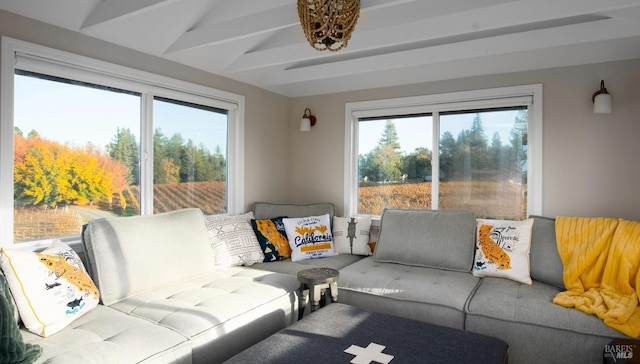 living area featuring vaulted ceiling with beams