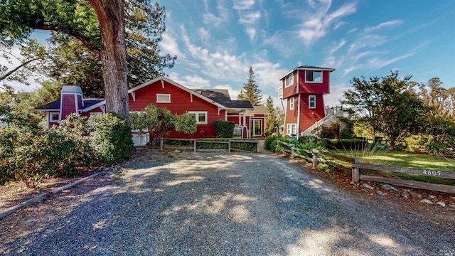 exterior space featuring driveway and fence