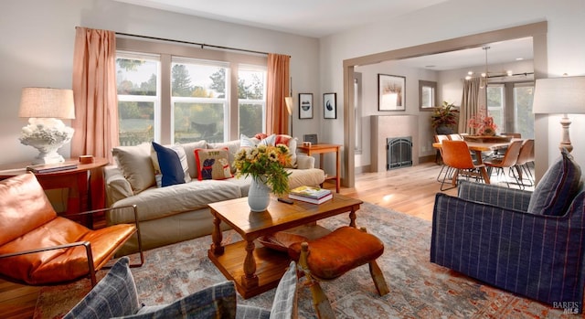 living area featuring wood finished floors and a tile fireplace