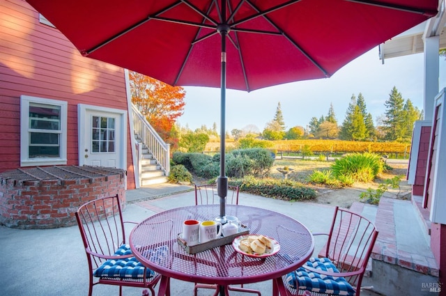 view of patio / terrace with outdoor dining space and stairway