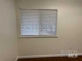 spare room featuring baseboards