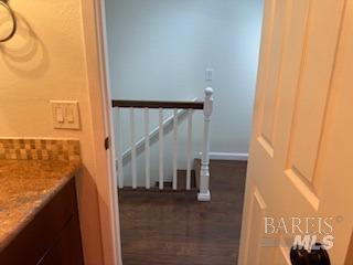 interior space with baseboards and wood finished floors