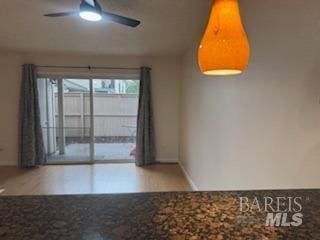 empty room featuring a ceiling fan and baseboards