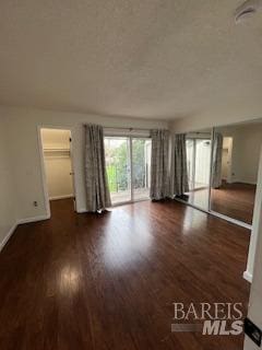 unfurnished room featuring baseboards and wood finished floors