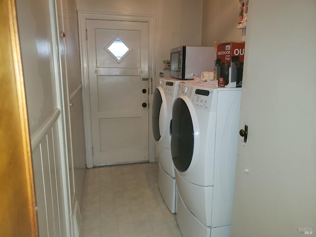 laundry room with laundry area, light floors, and washing machine and clothes dryer