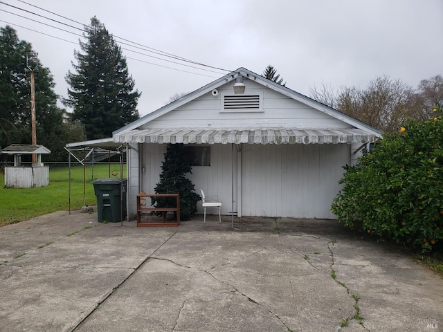 view of side of property featuring a patio area and a lawn