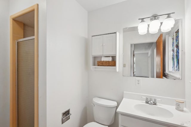 full bath featuring a shower stall, vanity, and toilet