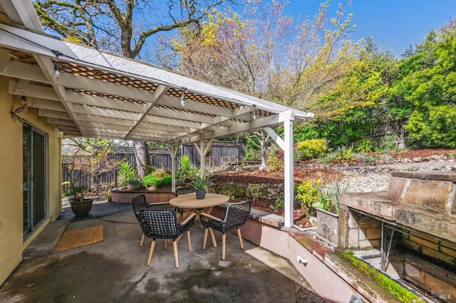 view of patio / terrace with a pergola, outdoor dining area, and fence