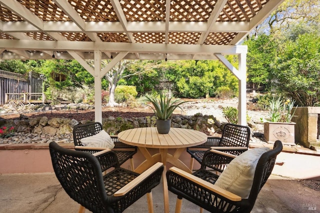 view of patio featuring a pergola, outdoor dining area, and fence