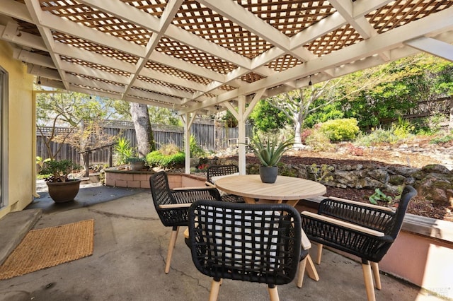 view of patio with a pergola, outdoor dining area, and fence