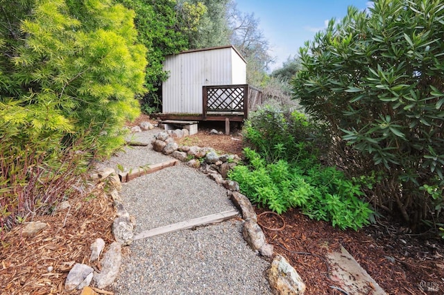 view of yard featuring an outbuilding and a storage shed