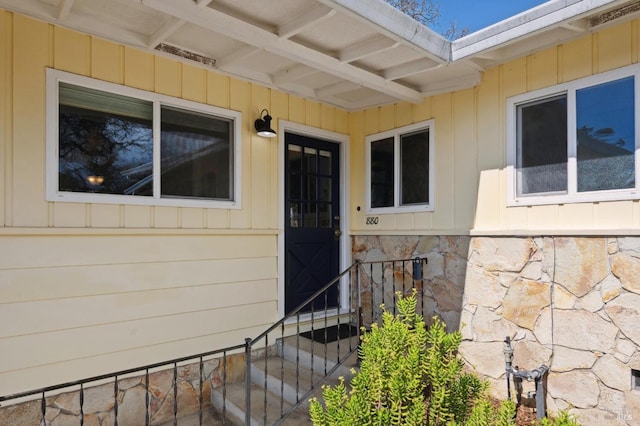 entrance to property featuring stone siding