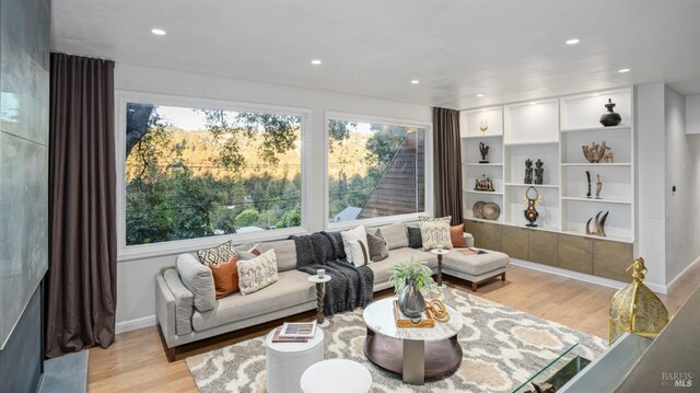 dining space featuring baseboards, wallpapered walls, wood finished floors, and an inviting chandelier