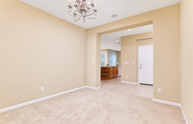 503 Twin Lakes Ln, Rio Vista, CA 94571 - empty room featuring recessed lighting, a sink, baseboards, light colored carpet, and a notable chandelier