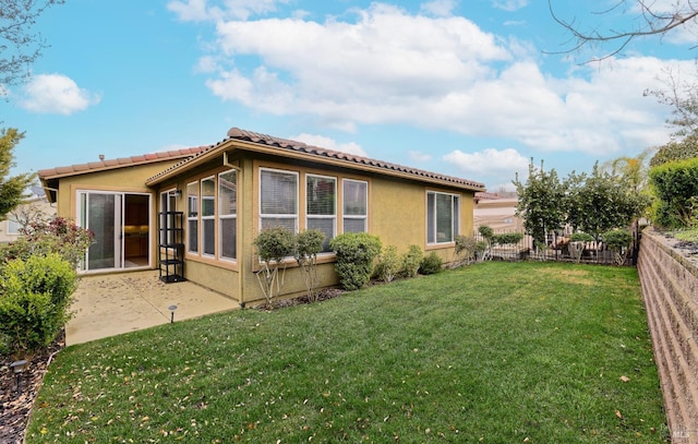 503 Twin Lakes Ln, Rio Vista, CA 94571 - back of house featuring a tiled roof, fence, a patio area, a yard, and stucco siding