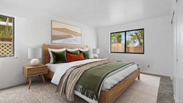 carpeted bedroom featuring baseboards