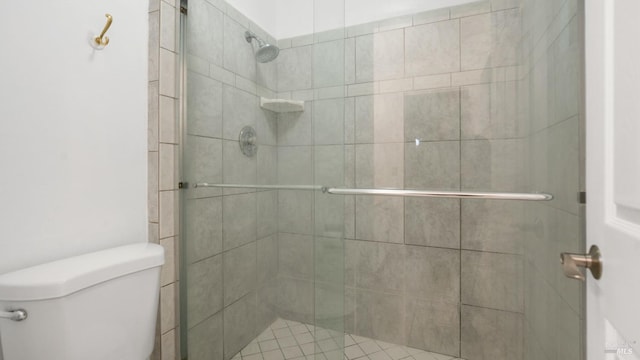 bathroom featuring a shower stall and toilet