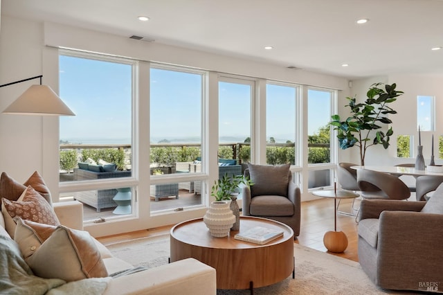 interior space with light wood finished floors, plenty of natural light, and recessed lighting