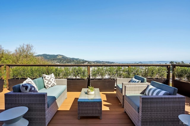 deck with a mountain view and an outdoor hangout area
