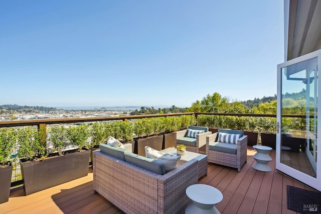 wooden terrace featuring an outdoor living space