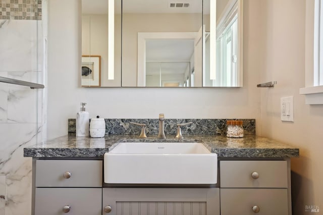 bathroom featuring vanity and visible vents