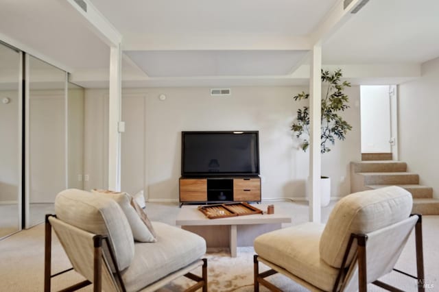 living room featuring stairs, baseboards, visible vents, and carpet floors