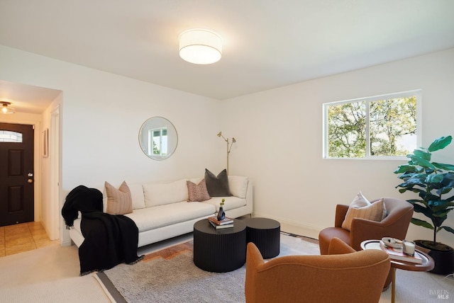living area with light tile patterned floors and baseboards