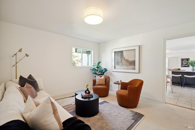 carpeted living room featuring baseboards