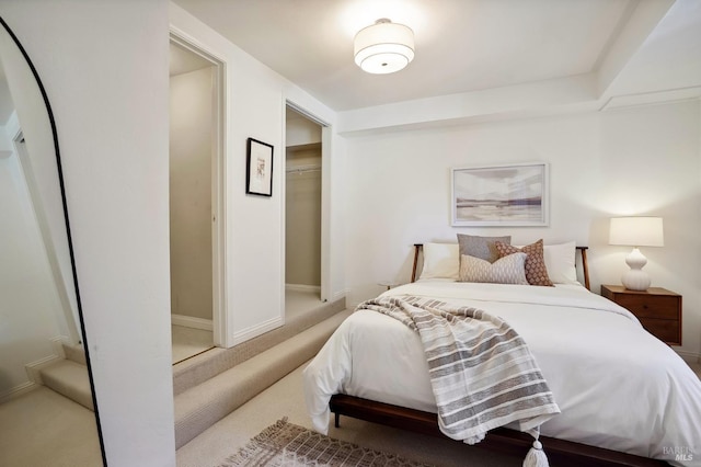 carpeted bedroom with baseboards and a closet