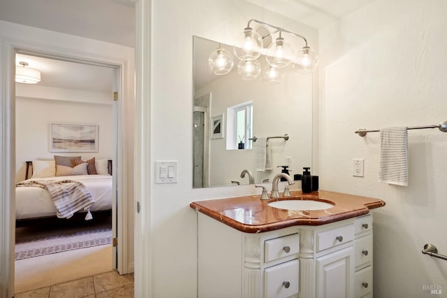 ensuite bathroom featuring vanity, tile patterned floors, and ensuite bath