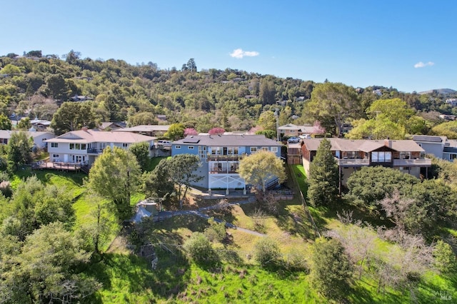 drone / aerial view with a residential view and a view of trees