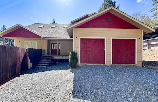 ranch-style house with a porch, an attached garage, and fence