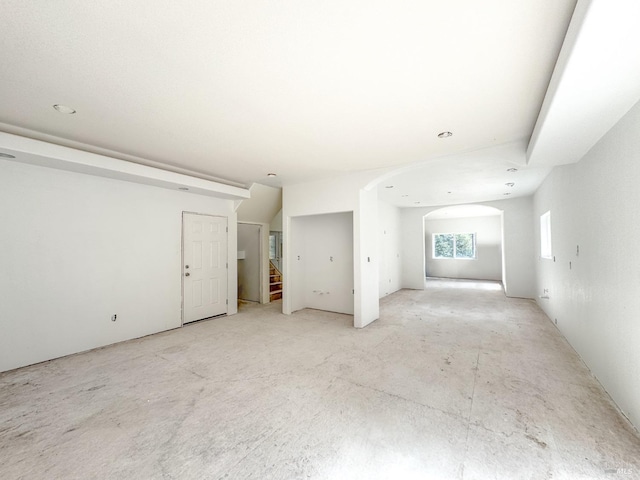 empty room with stairway and arched walkways