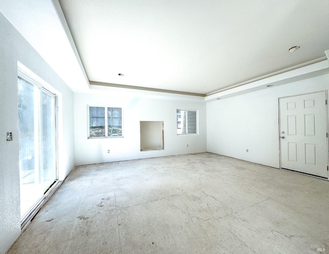 unfurnished living room featuring a raised ceiling