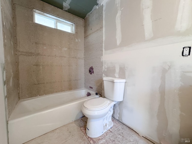 bathroom with a tub and toilet