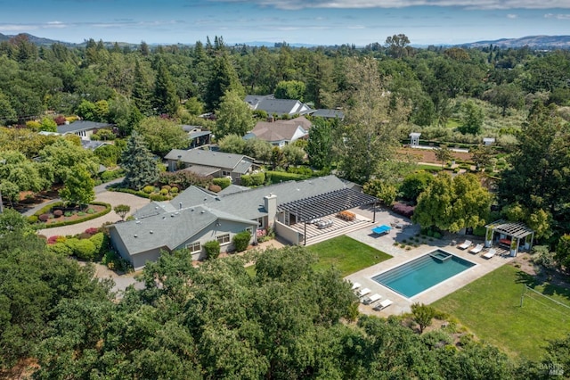 aerial view featuring a wooded view