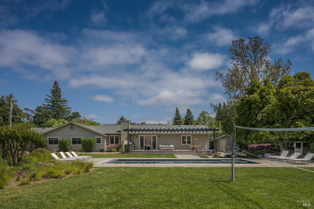 rear view of property with an outdoor pool, a yard, a patio, and an outdoor structure