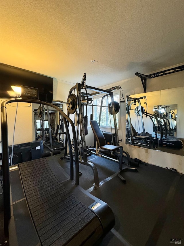 gym featuring a textured ceiling