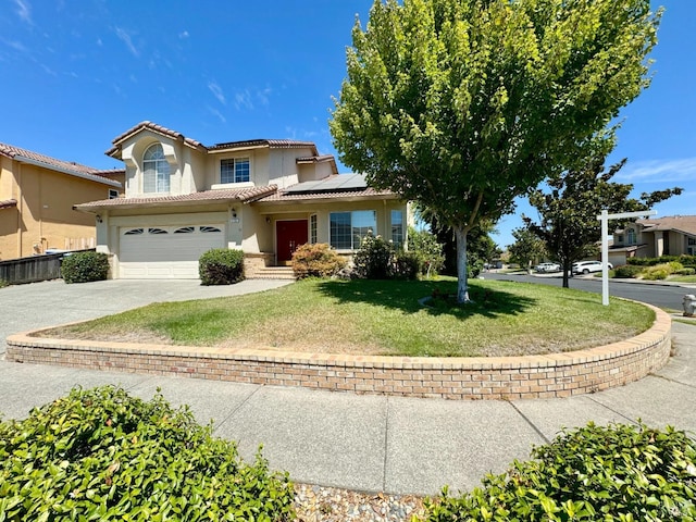 view of front of home with a front lawn, concrete driveway, a tile roof, roof mounted solar panels, and stucco siding